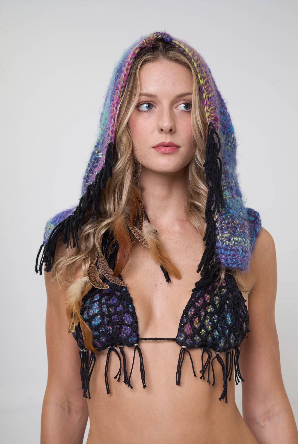 Model wearing the Metamorphosis hoodie with a crochet hood on a white background