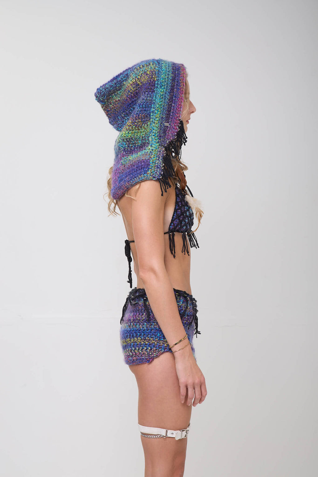 Side view of model wearing the Metamorphosis hoodie on a white background