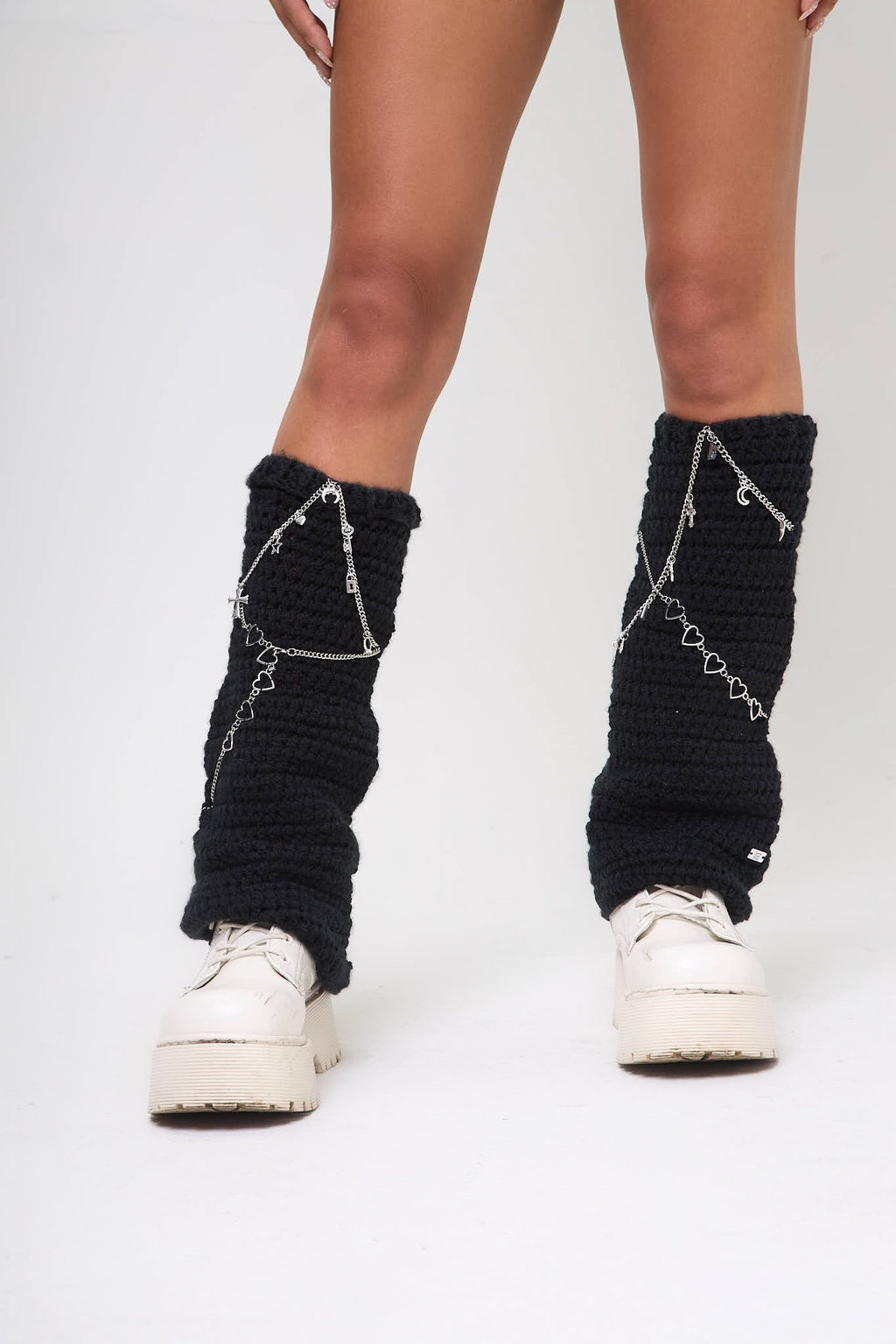 Close-up front view of the Not My First Rodeo leg warmers worn with white sneakers