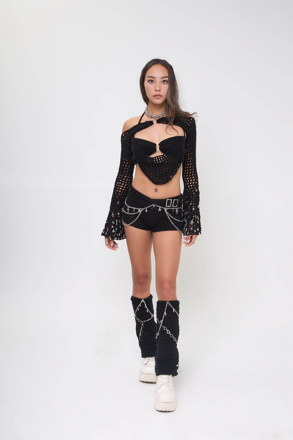 Model wearing the Not My First Rodeo leg warmers styled with a matching outfit on a white background