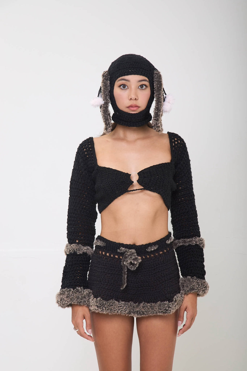 Model wearing the black Not Your Baby balaclava styled with a full outfit on a white background