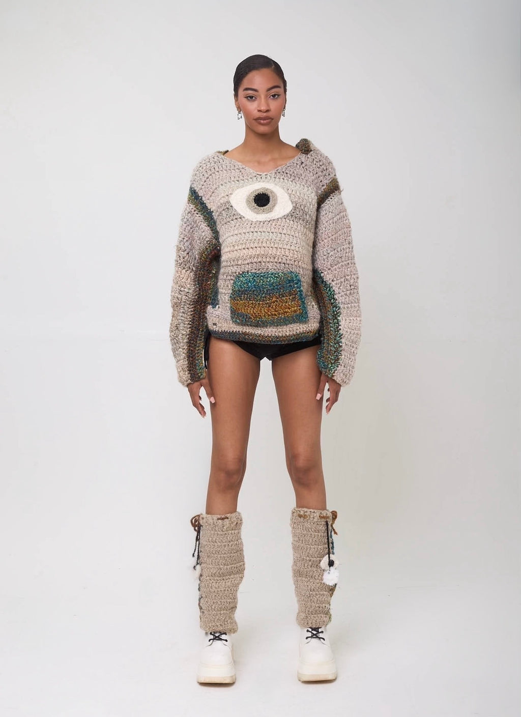 Model wearing handmade crochet See No Evil hoodie with evil eye design