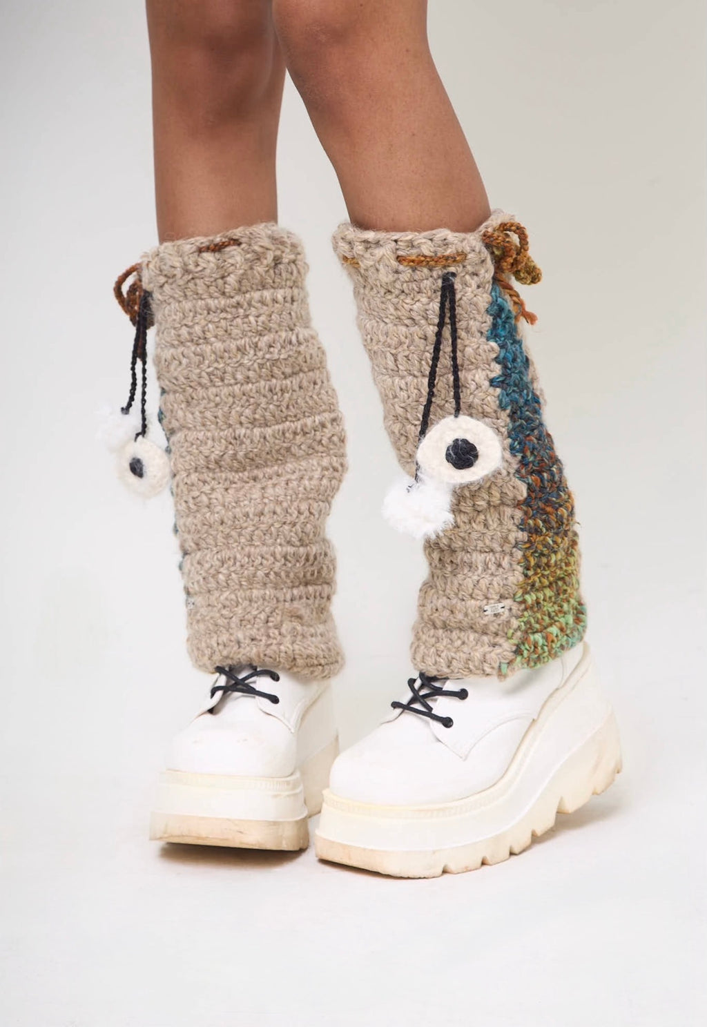 Front view of crochet leg warmers with evil eye charm