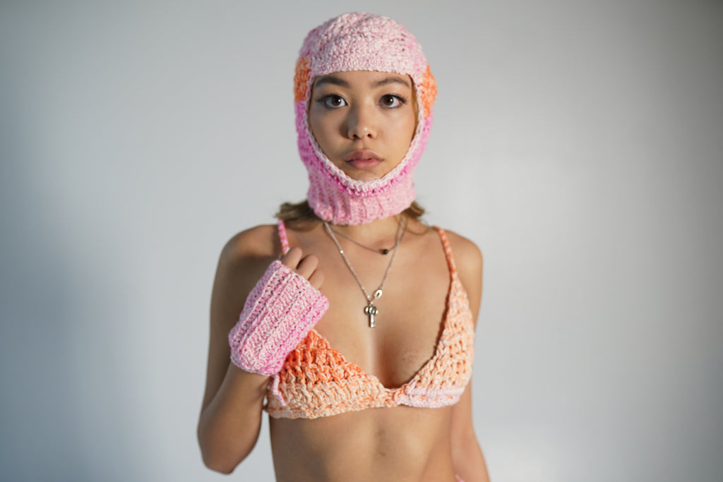 Close up of orange and pink crochet balaclava texture