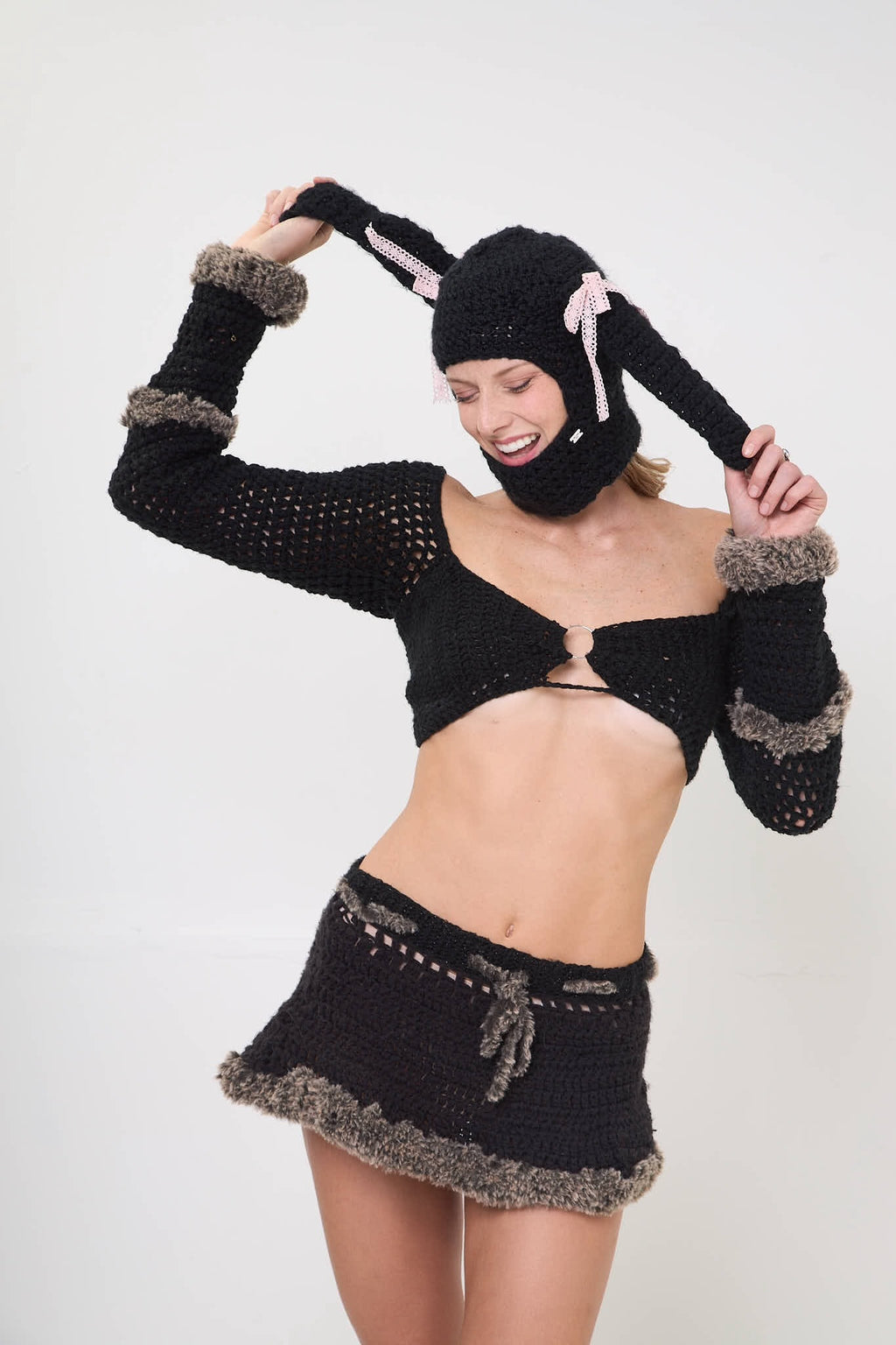 Model wearing the Sweetie Bunny balaclava styled with a black outfit on a white background