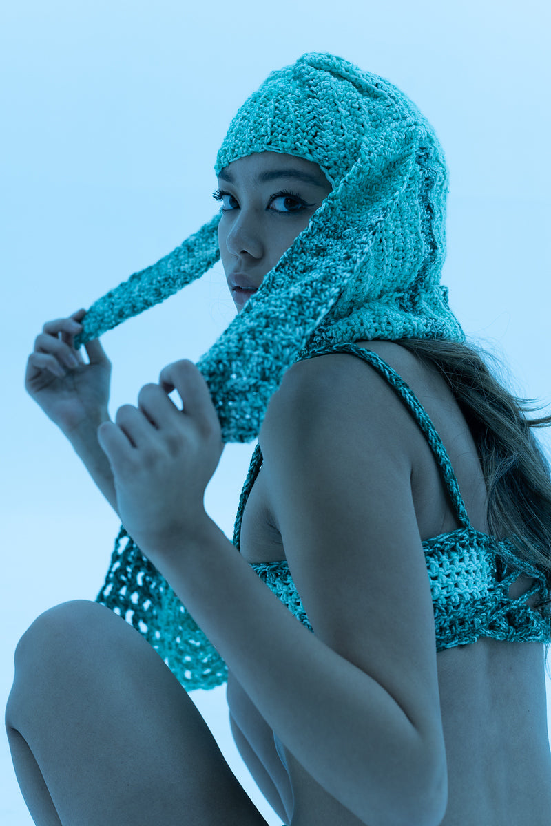 Model wearing blue ombré crochet balaclava with bunny ears