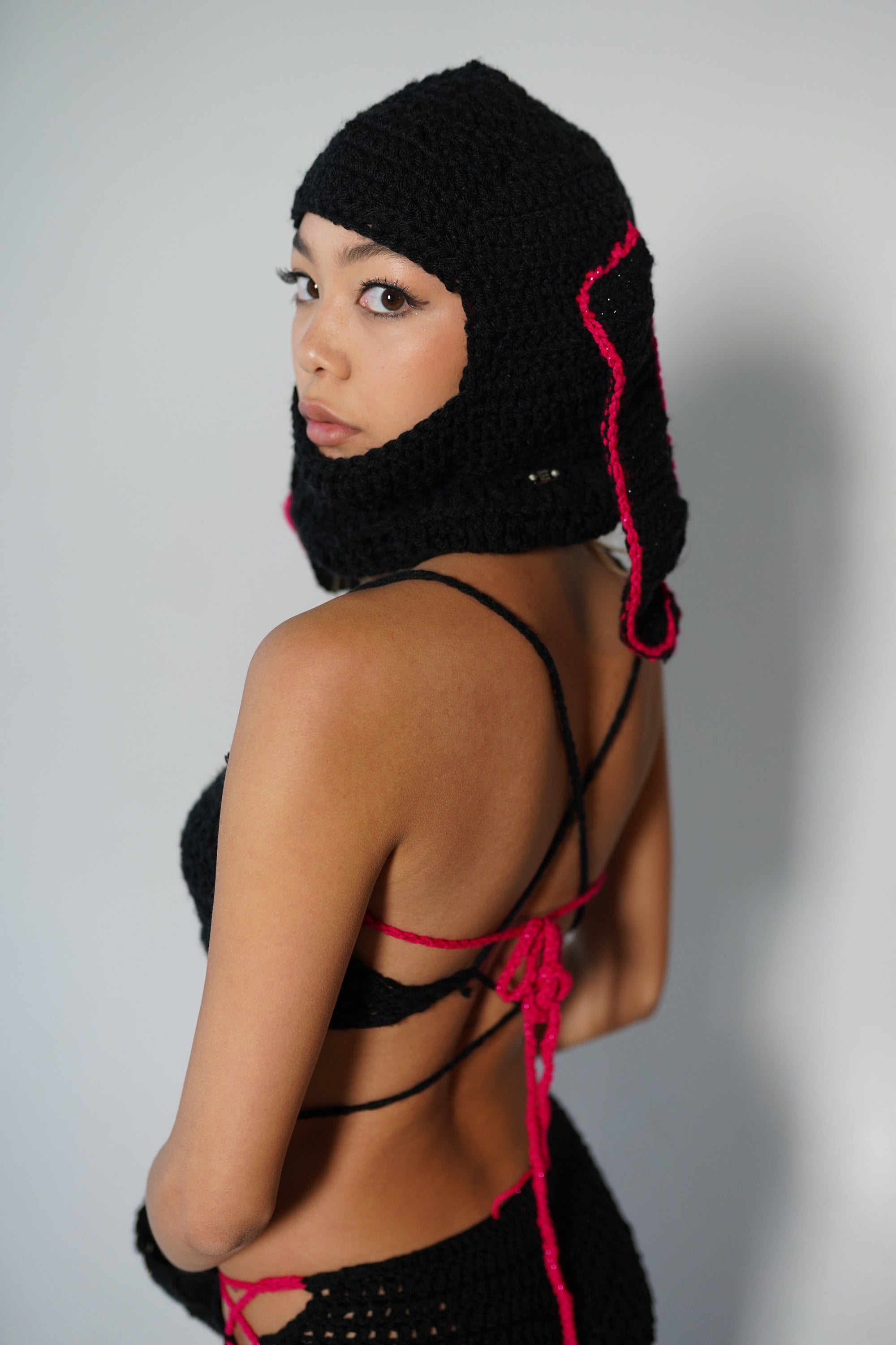 Black crochet balaclava back view with star accent