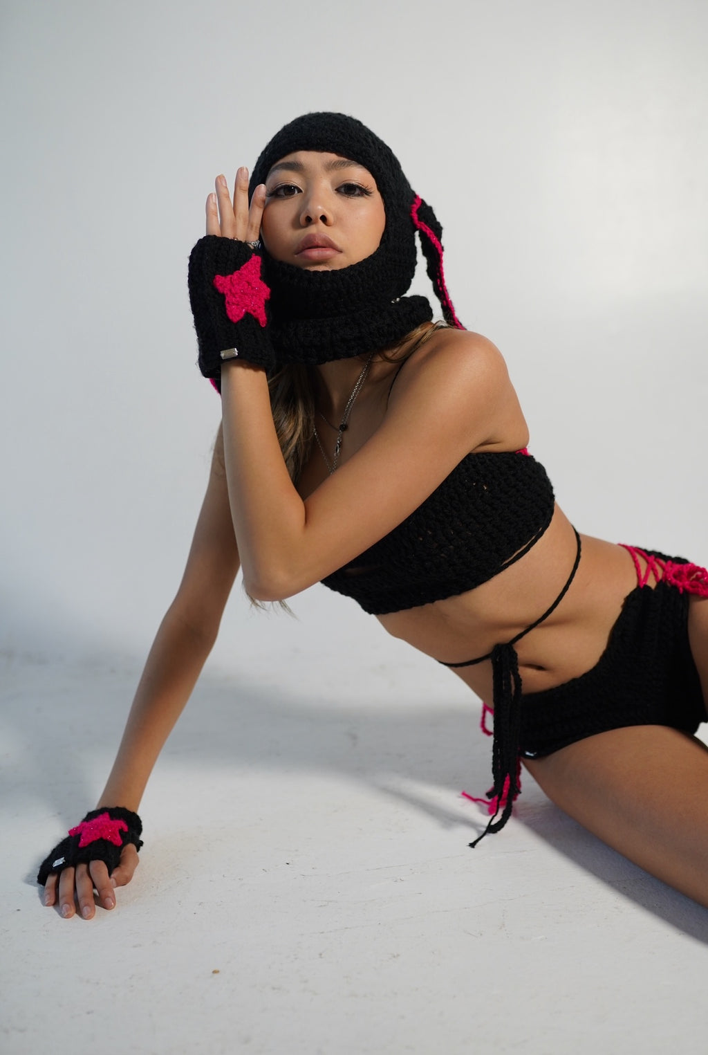 Black crochet wrist warmers with hot pink star details